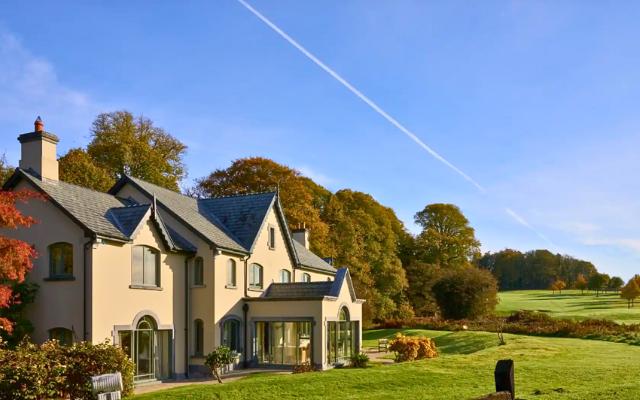 Lodge looking over golf course with autumnal trees