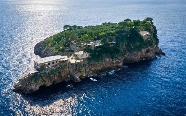 Private island with villa built into the side of a cliff